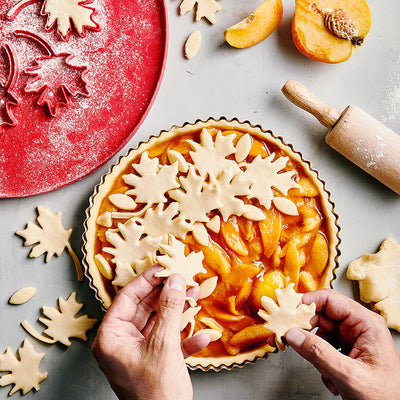Nordic Ware 12 Inch Leaves & Apples Reversible Pie Top Cutter available at American Swedish Institute.